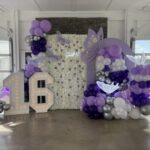 Sweet 16 party decorations with purple balloons.