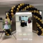 Balloon arch entrance with festive decorations.